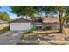 Charming single-story home featuring an attached garage, mature tree, tidy lawn, and a walkway to the front door at 6547 Samoa Dr, Sarasota, FL 34241