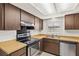 Cozy kitchen featuring wooden cabinets, stainless steel appliances and light countertops at 6547 Samoa Dr, Sarasota, FL 34241