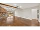 Bright, spacious living area featuring a stone fireplace, vaulted ceilings, wood floors, and slider door access at 6547 Samoa Dr, Sarasota, FL 34241