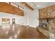 Open living room with wood floors, stone fireplace, and vaulted ceilings at 6547 Samoa Dr, Sarasota, FL 34241