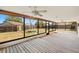 Enclosed patio with ceiling fans and view of fenced-in backyard with fire pit at 6547 Samoa Dr, Sarasota, FL 34241