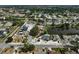 Neighborhood aerial view showcasing lush landscaping, community lake and charming single-Gathering homes at 6924 34Th W Ave, Bradenton, FL 34209