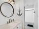 Charming bathroom with modern vanity, round mirror, and an anchor decoration adding a nautical touch at 6924 34Th W Ave, Bradenton, FL 34209