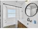 Bright bathroom features a tub, shower, round mirror and stylish mosaic tile at 6924 34Th W Ave, Bradenton, FL 34209