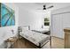 Bright bedroom with two beds, a ceiling fan, and ample natural light from the window at 6924 34Th W Ave, Bradenton, FL 34209