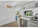 Kitchen with a view of the pool area through sliding glass doors, featuring modern appliances and storage at 6924 34Th W Ave, Bradenton, FL 34209
