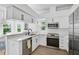 Modern kitchen with white cabinets, stainless steel appliances, and a convenient breakfast bar with great natural light at 6924 34Th W Ave, Bradenton, FL 34209