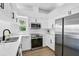 Modern kitchen features white cabinets, stainless steel appliances and a bright window view at 6924 34Th W Ave, Bradenton, FL 34209