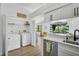Convenient laundry area with washer, dryer, and folding space adjacent to kitchen at 6924 34Th W Ave, Bradenton, FL 34209