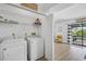 Laundry area with washer and dryer, shelving and access to backyard and pool at 6924 34Th W Ave, Bradenton, FL 34209