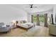 Bright main bedroom with large windows and a comfy accent chair showcasing a warm, inviting space at 6924 34Th W Ave, Bradenton, FL 34209
