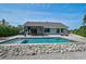 Beautiful backyard with a sparkling pool, comfortable lounge chairs, and a covered dining area at 6924 34Th W Ave, Bradenton, FL 34209
