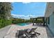Charming backyard oasis with a sparkling pool, inviting lounge area, and verdant landscaping for ultimate relaxation at 6924 34Th W Ave, Bradenton, FL 34209