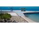 Waterfront dock with boats passing by at 7 Sandy Cove Rd, Sarasota, FL 34242