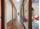 Bright hallway featuring tile flooring, a glass wall, and a view of the outdoor patio at 7 Sandy Cove Rd # 9B, Sarasota, FL 34242