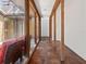 Bright hallway featuring tile flooring, a glass wall, and a view of the outdoor patio at 7 Sandy Cove Rd, Sarasota, FL 34242