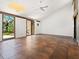 Open living room with tile floors, ceiling fan and sliding glass doors leading to an outdoor view at 7 Sandy Cove Rd, Sarasota, FL 34242