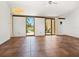 Bright living room with tile floors, ceiling fan and sliding glass doors leading to an outdoor view at 7 Sandy Cove Rd, Sarasota, FL 34242