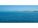 Expansive ocean view with buildings along the coastline in the distance at 7 Sandy Cove Rd, Sarasota, FL 34242