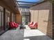 Cozy outdoor patio with comfortable seating, brick walls, and a skylight for natural light at 7 Sandy Cove Rd, Sarasota, FL 34242