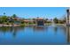Scenic view of waterfront properties set around a picturesque pond with fountain and lush landscaping at 7 Sandy Cove Rd, Sarasota, FL 34242