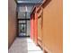 Exterior walkway between brick walls with a skylight and view towards a sliding glass door at 7 Sandy Cove Rd, Sarasota, FL 34242