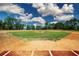 Exterior shot of a baseball field featuring lush green grass and red clay at 7168 Chatum Light Run, Bradenton, FL 34212