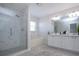 Bathroom with double sink vanity, soaking tub, glass enclosed shower and tile flooring at 7168 Chatum Light Run, Bradenton, FL 34212