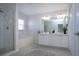 Bathroom with double sink vanity, soaking tub, glass enclosed shower and tile flooring at 7168 Chatum Light Run, Bradenton, FL 34212