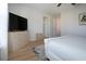 Bedroom boasts a TV on dresser, a door to the hall, and a ceiling fan at 7168 Chatum Light Run, Bradenton, FL 34212