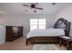 This bedroom offers a ceiling fan, a wooden dresser, and an upholstered headboard bed at 7168 Chatum Light Run, Bradenton, FL 34212
