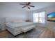 This bedroom features a ceiling fan and a tufted headboard bed with bench at 7168 Chatum Light Run, Bradenton, FL 34212