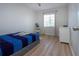 This bedroom features wood-look floors, a ceiling fan, a window, and a bed at 7168 Chatum Light Run, Bradenton, FL 34212
