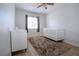 This bedroom features wood-look floors, a ceiling fan, and a white crib with a shag rug at 7168 Chatum Light Run, Bradenton, FL 34212