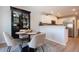 Cozy dining area with seating for four, a modern light fixture, and bright natural light at 7168 Chatum Light Run, Bradenton, FL 34212