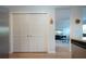 Hallway closet with bi-fold doors and a view into the living room with TV at 7168 Chatum Light Run, Bradenton, FL 34212