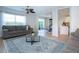 Open-concept living room filled with natural light, features modern furnishings, and flows seamlessly into the dining area at 7168 Chatum Light Run, Bradenton, FL 34212