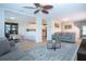 Open-concept living room filled with natural light, features modern furnishings, and flows seamlessly into the dining area at 7168 Chatum Light Run, Bradenton, FL 34212