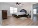 Bright main bedroom featuring a ceiling fan, and a large window for natural light at 7168 Chatum Light Run, Bradenton, FL 34212