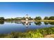 This pond features a lighthouse in the middle, palm trees, and landscaping around the water at 7168 Chatum Light Run, Bradenton, FL 34212