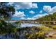 Scenic view of a pond with a wooden bridge, trees, and a beautiful reflection on the water at 7168 Chatum Light Run, Bradenton, FL 34212