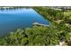 This pond features a fishing pier, green trees around the pond, and a sidewalk at 7168 Chatum Light Run, Bradenton, FL 34212