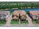 Beautiful aerial view of a multi-Gathering home with lake view and paved driveway at 7425 Divot Loop, Lakewood Ranch, FL 34202