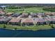 Aerial view of a multi-Gathering home on waterfront property that overlooks a golf course at 7425 Divot Loop, Lakewood Ranch, FL 34202