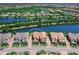 Lovely aerial view of a home in a beautiful community with a serene lake nearby at 7425 Divot Loop, Lakewood Ranch, FL 34202