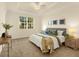 Bright bedroom featuring a queen-sized bed, neutral decor, and natural light from the window at 7425 Divot Loop, Lakewood Ranch, FL 34202