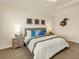 Comfortable bedroom featuring a queen-sized bed with decorative pillows and ample lighting at 7425 Divot Loop, Lakewood Ranch, FL 34202