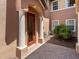 Multi-Gathering home entryway featuring a red front door, white columns, and a brick walkway at 7425 Divot Loop, Lakewood Ranch, FL 34202