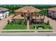 Charming front exterior of a home featuring manicured landscaping and a paved driveway at 7425 Divot Loop, Lakewood Ranch, FL 34202