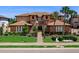 Inviting multi-Gathering home featuring lush landscaping, sidewalks, and large windows at 7425 Divot Loop, Lakewood Ranch, FL 34202